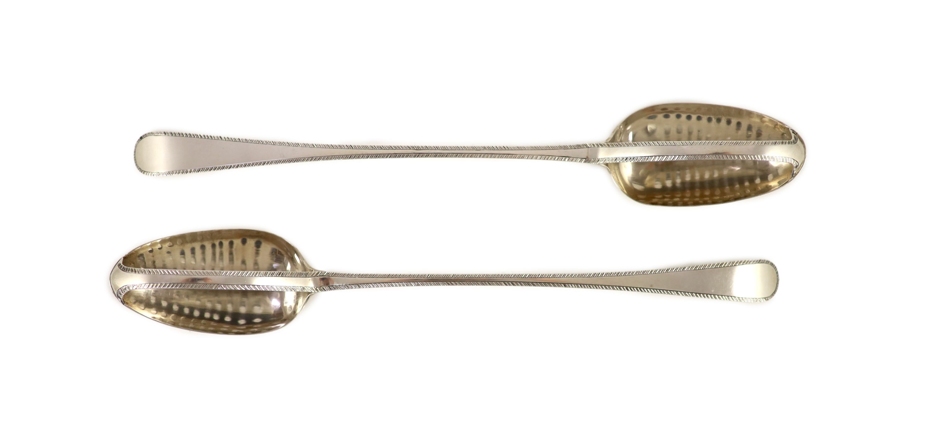 A pair of George III silver feather edge Old English pattern straining spoons, marks pinched